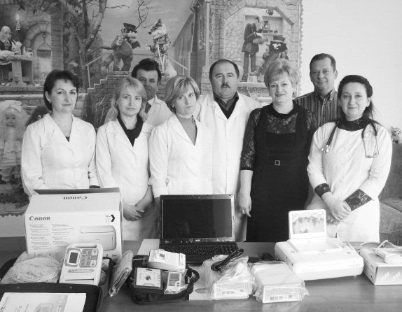 2 - Medical personnel of Halych Central Hospital stand behind cardiovascular equipment donated by CCCF