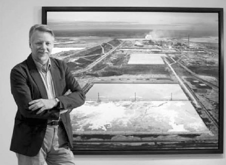 Edward Burtynsky at the Royal Ontario Museum with his “Oil Sands #6” from 2007, of an oil sands extraction site near Fort McMurray, Alta