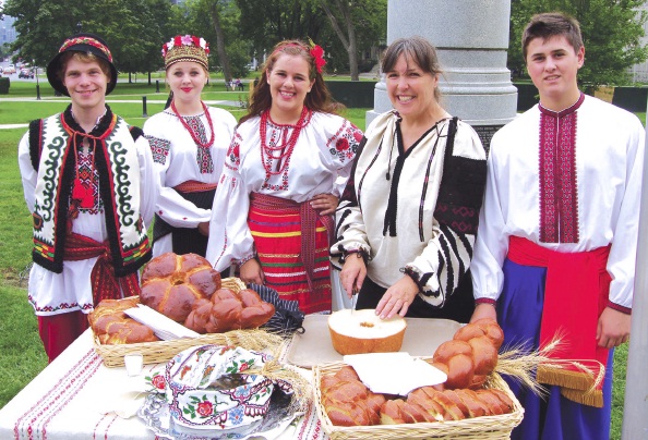 1 - UWO of Canada NE President Yaroslava Iwasykiw enacting Breaking of Bread with members of Odessa Ukrainian Dancers