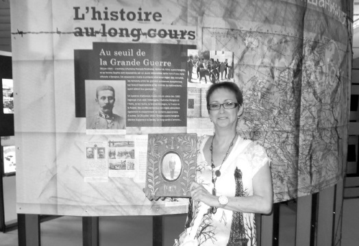 Pauline Quessy at the Camp Spirit Lake Internment Interpretive Centre holding her unique donation dated from 1916 made by Spirit Lake internee number 886